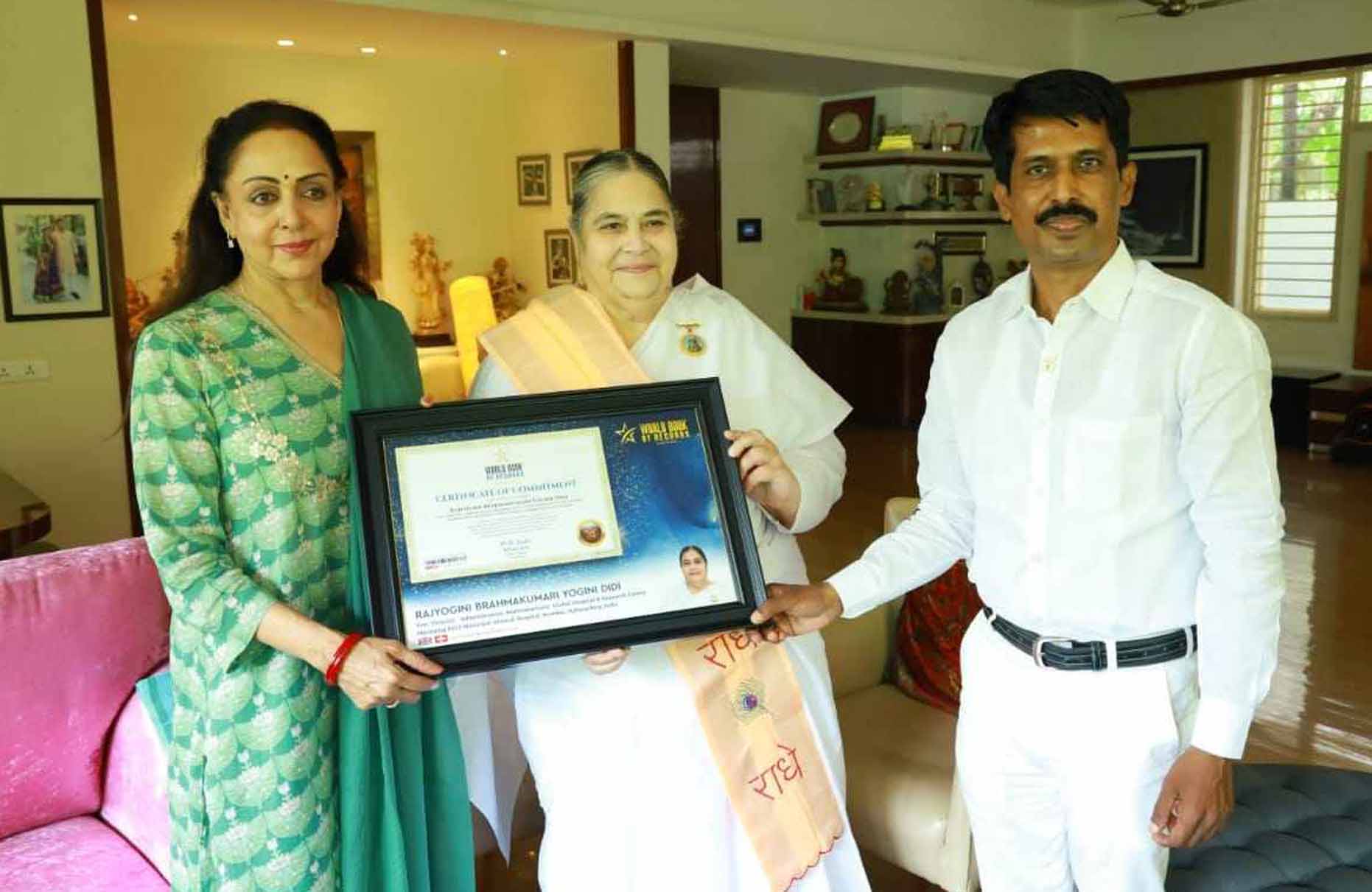 Honourable Hema Malini bestows the certificate of Commitment (Switzerland) to Rajyogini Brahmakumari Yogini Didi
